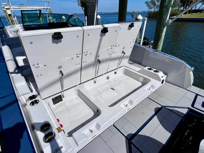 Impulse Yacht Photos Pics 2022 Aviara AV 32 Outboard boat with open storage compartments by the water.