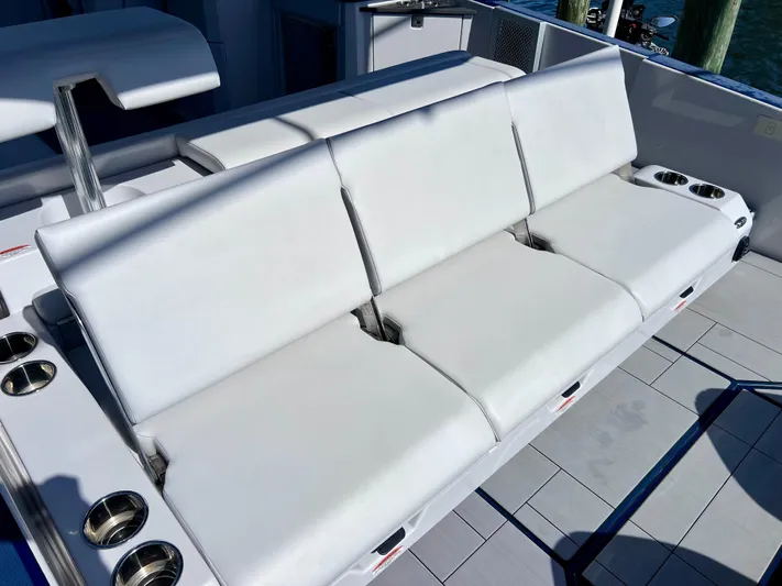 Impulse Yacht Photos Pics 2022 Aviara AV 32 Outboard boat with white cushioned seating and cup holders.