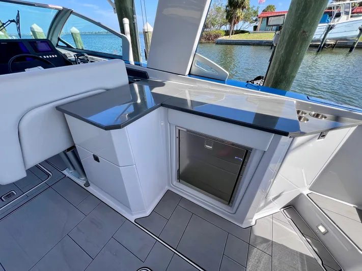 Impulse Yacht Photos Pics 2022 Aviara AV 32 Outboard boat interior with sleek kitchenette and waterfront view.