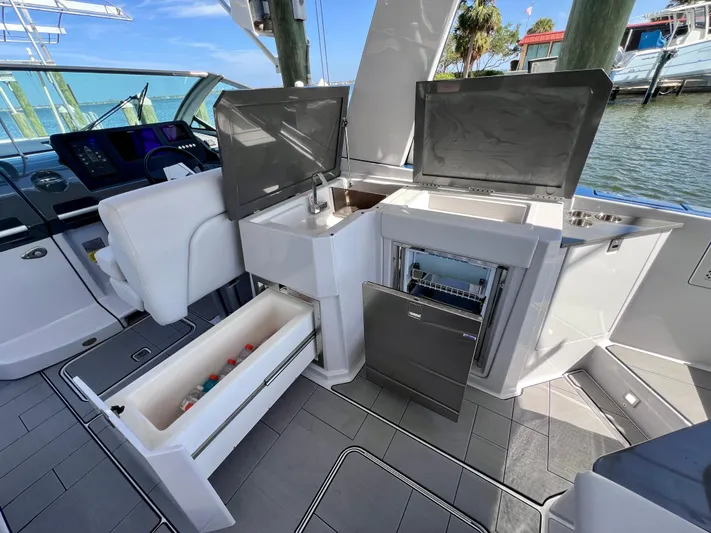 Impulse Yacht Photos Pics Aviara AV 32 Outboard 2022 boat interior with open storage and seating area.