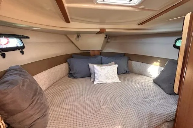 Sea Glass II Yacht Photos Pics 2024 Ranger Tugs R-27 Luxury Edition cabin with cozy bedding and pillows.