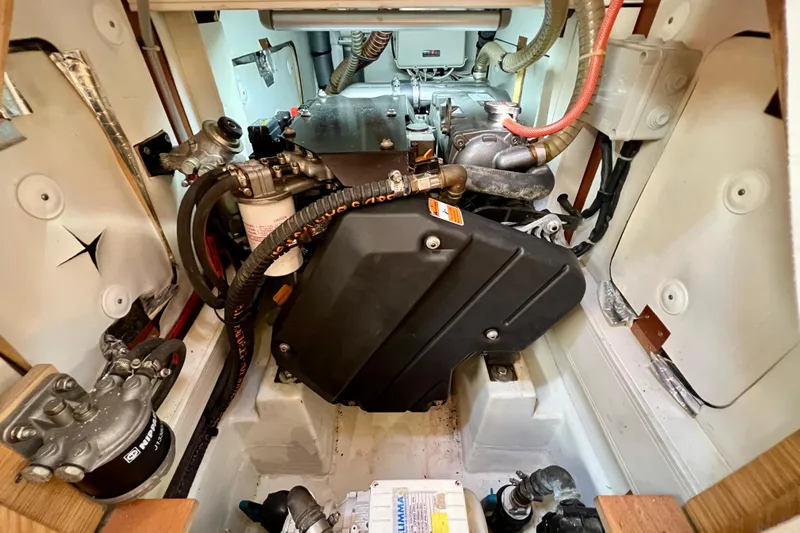Gr Yacht Photos Pics Engine compartment of a 2017 Grand Soleil 52LC sailboat, showcasing mechanical components and wiring.