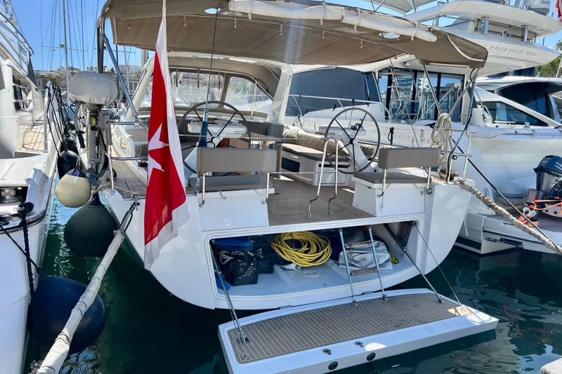 Gr Yacht Photos Pics 2017 Grand Soleil 52LC yacht docked, featuring dual steering wheels and a red flag.