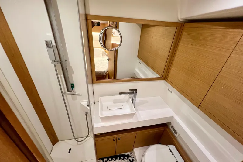 Gr Yacht Photos Pics Modern bathroom interior of 2017 Grand Soleil 52LC yacht with sleek fixtures and wood accents.