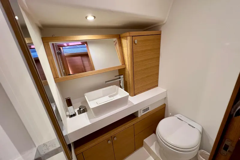 Gr Yacht Photos Pics Luxurious bathroom in 2017 Grand Soleil 52LC yacht with modern fixtures and wooden cabinetry.