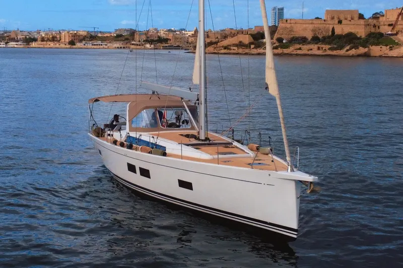 Gr Yacht Photos Pics Grand Soleil 52LC 2017 yacht sailing near a historic coastal city.