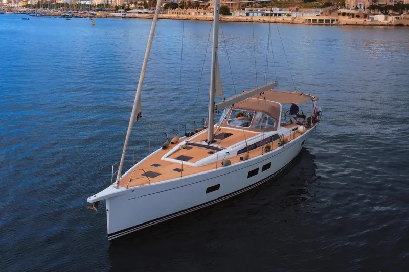 Gr Yacht Photos Pics Grand Soleil 52LC 2017 sailboat on calm water near coastal town.