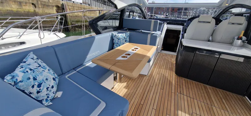  Yacht Photos Pics Interior of 2024 Fairline Targa 40 yacht with blue seating and wooden flooring.