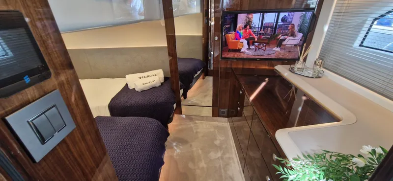  Yacht Photos Pics Interior of Fairline Targa 40 yacht, 2024 model, featuring luxurious bedroom and TV.