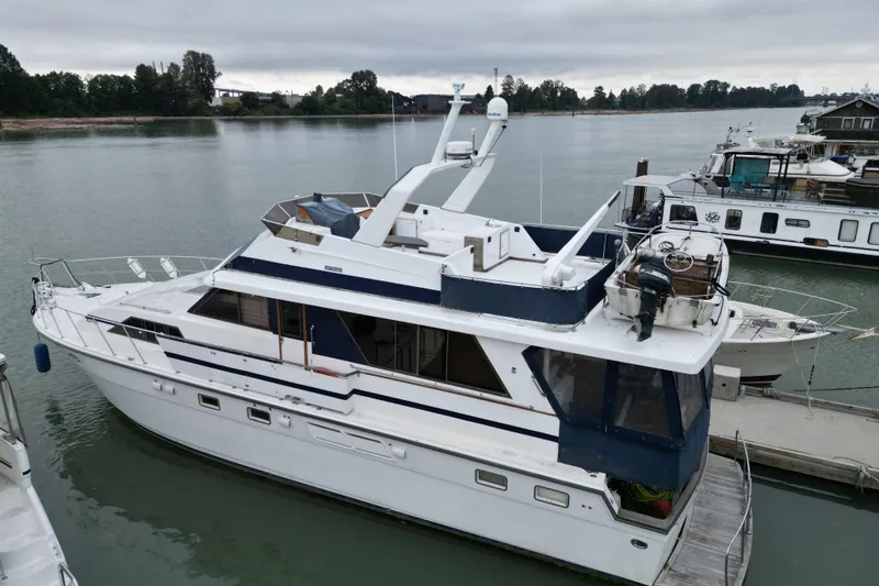 Qui-si-sana Yacht Photos Pics 1989 Jefferson 52 Victory yacht docked on a calm river under overcast skies.