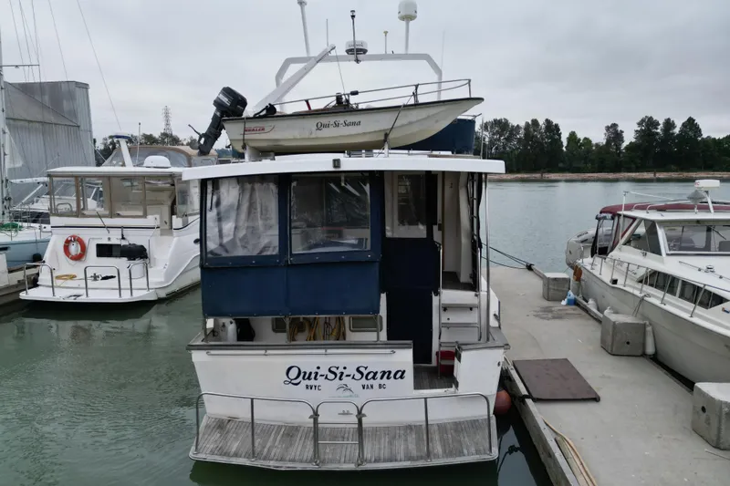 Qui-si-sana Yacht Photos Pics A 1989 Jefferson 52 Victory boat named "Qui-Si-Sana" docked at a marina.