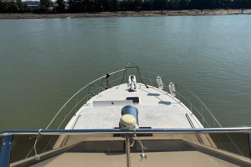 Qui-si-sana Yacht Photos Pics Bow view of 1989 Jefferson 52 Victory yacht on calm river waters.