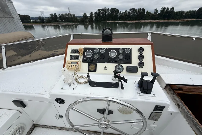 Qui-si-sana Yacht Photos Pics Control panel of a 1989 Jefferson 52 Victory boat with steering wheel and gauges.
