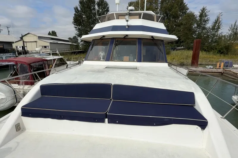 Qui-si-sana Yacht Photos Pics 1989 Jefferson 52 Victory yacht with blue cushions docked at marina.