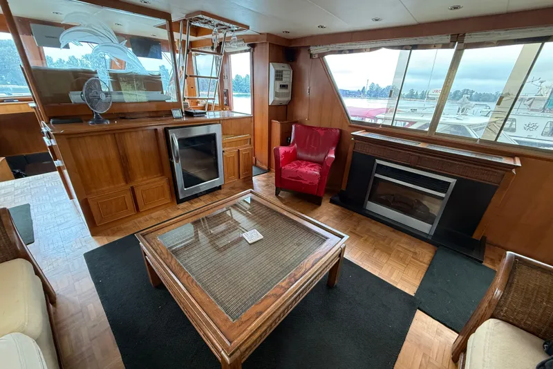 Qui-si-sana Yacht Photos Pics Luxurious interior of 1989 Jefferson 52 Victory yacht with elegant wood finishes.