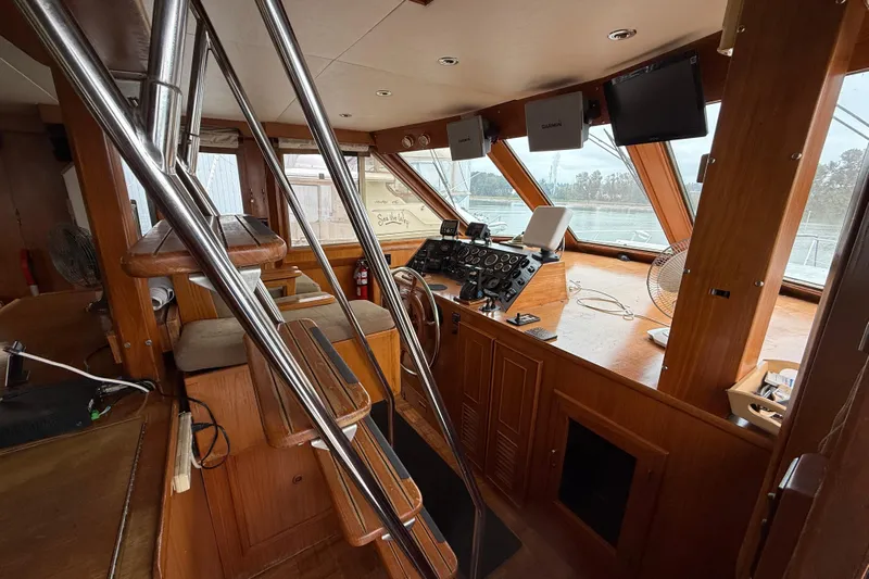 Qui-si-sana Yacht Photos Pics Interior of 1989 Jefferson 52 Victory yacht with wooden helm and navigation equipment.