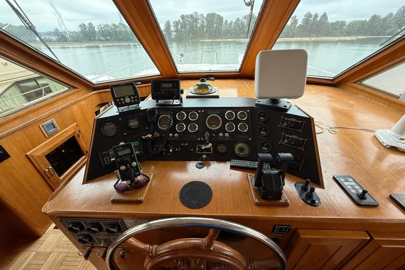 Qui-si-sana Yacht Photos Pics 1989 Jefferson 52 Victory yacht helm with navigation instruments and wooden steering wheel.