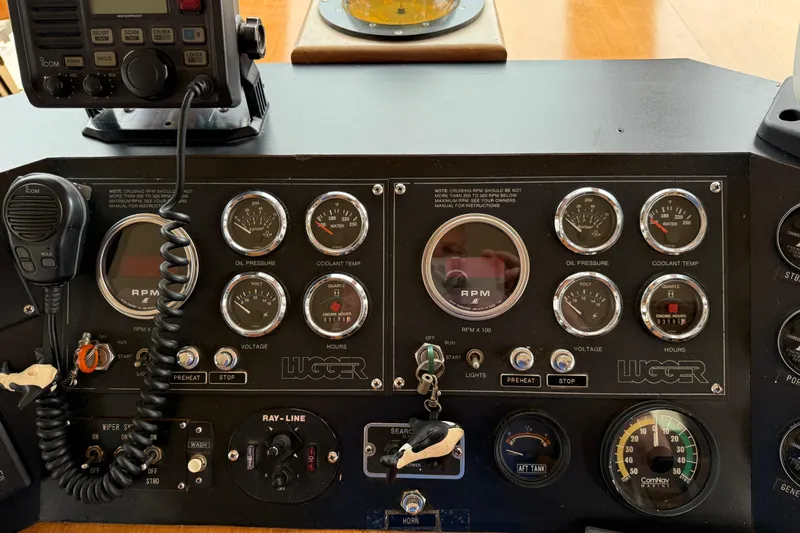 Qui-si-sana Yacht Photos Pics Control panel of a 1989 Jefferson 52 Victory boat with gauges and radio equipment.