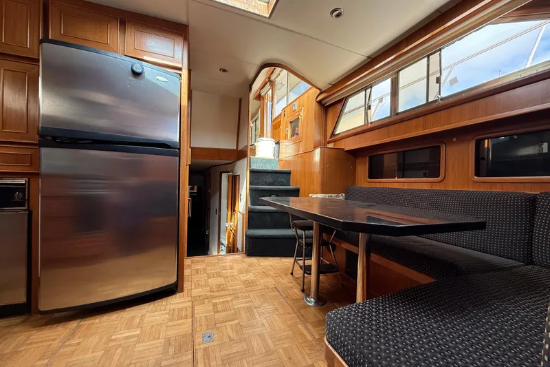 Qui-si-sana Yacht Photos Pics Interior of 1989 Jefferson 52 Victory yacht with kitchen and dining area.
