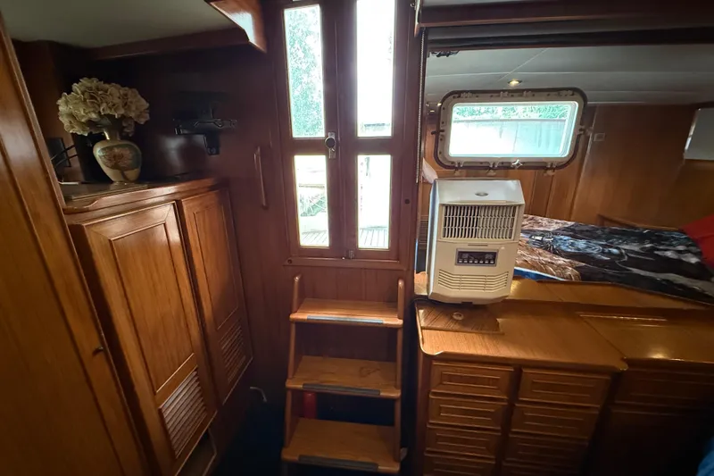 Qui-si-sana Yacht Photos Pics Cozy interior of 1989 Jefferson 52 Victory yacht with wooden cabinetry and natural light.