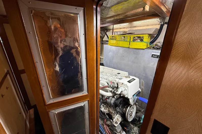 Qui-si-sana Yacht Photos Pics Engine room of 1989 Jefferson 52 Victory yacht with visible machinery and storage.