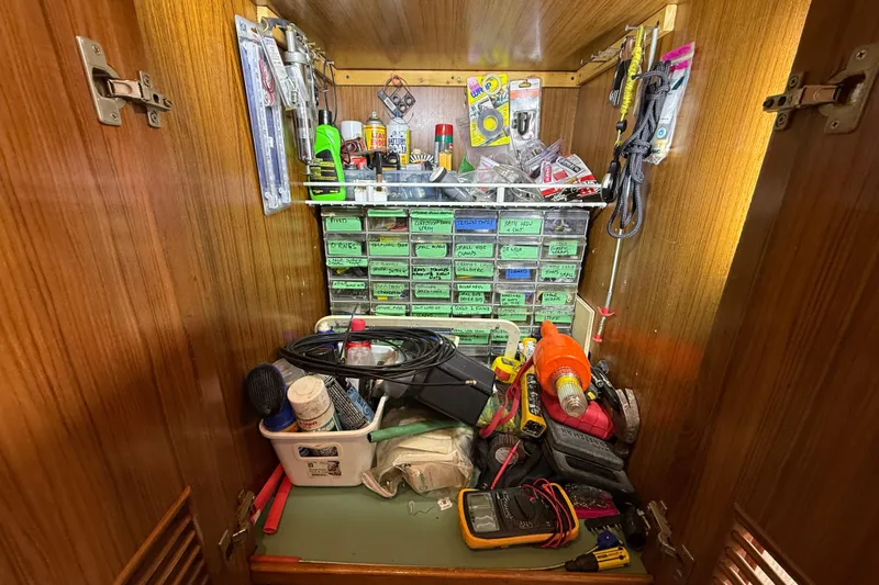 Qui-si-sana Yacht Photos Pics Organized tool cabinet in a 1989 Jefferson 52 Victory boat, featuring various tools and supplies.