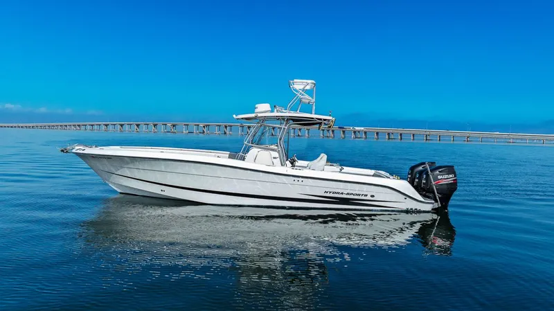  Yacht Photos Pics 2004 Hydra-Sports Vector 3300 CC on calm water near bridge.