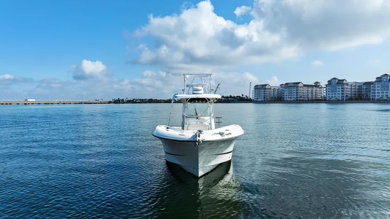  Yacht Photos Pics 2004 Hydra-Sports Vector 3300 CC on calm water near buildings.