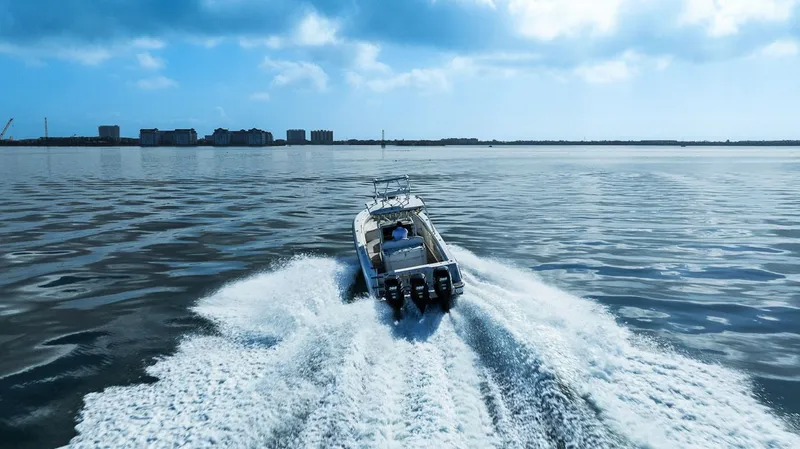  Yacht Photos Pics 2004 Hydra-Sports Vector 3300 CC on calm water under sunny sky.