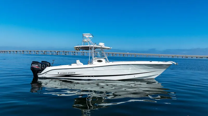  Yacht Photos Pics 2004 Hydra-Sports Vector 3300 CC on calm water near bridge.