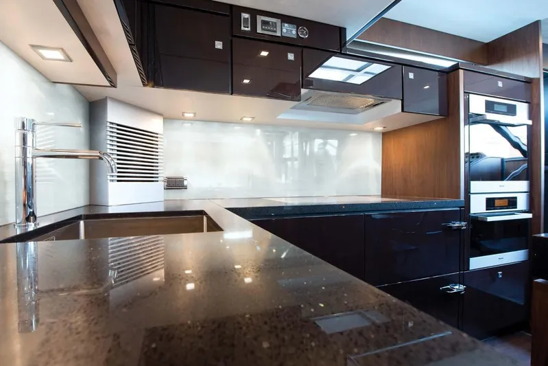  Yacht Photos Pics Luxurious kitchen interior of 2015 Fairline Squadron 78 yacht with modern appliances and sleek design.