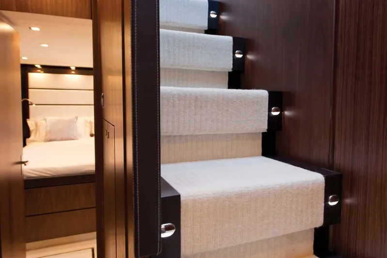  Yacht Photos Pics Luxurious interior of 2015 Fairline Squadron 78 yacht with carpeted stairs and cozy bedroom.