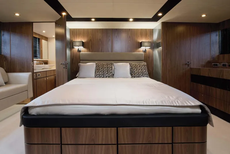  Yacht Photos Pics Luxurious bedroom interior of 2015 Fairline Squadron 78 yacht with modern wood paneling.