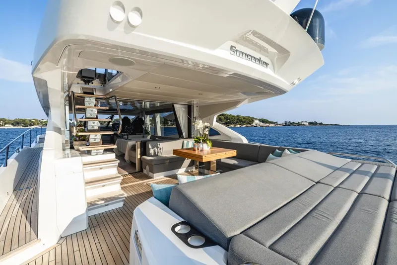 Jam Yacht Photos Pics 2018 Sunseeker 74 Sport Yacht with luxurious deck and seating, cruising on open water.