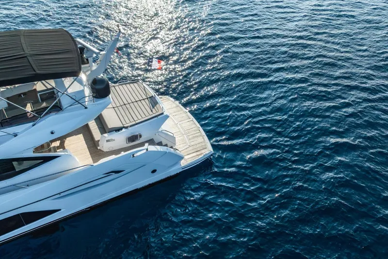 Jam Yacht Photos Pics Sunseeker 74 Sport Yacht 2018 on sparkling blue ocean waters, aerial view.