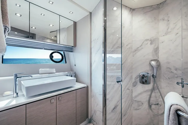 Jam Yacht Photos Pics Luxurious bathroom in 2018 Sunseeker 74 Sport Yacht with ocean view and modern fixtures.