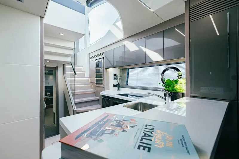 Jam Yacht Photos Pics Luxurious interior of 2018 Sunseeker 74 Sport Yacht with modern kitchen and staircase.