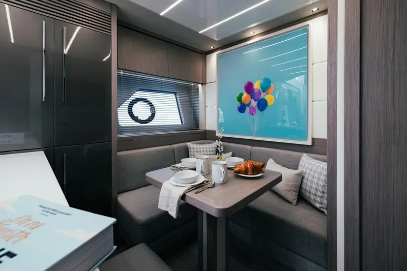 Jam Yacht Photos Pics Luxurious Sunseeker 74 Sport Yacht 2018 interior with dining area and colorful balloon artwork.