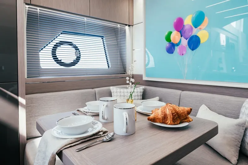 Jam Yacht Photos Pics Interior of 2018 Sunseeker 74 Sport Yacht with breakfast setting and colorful balloon artwork.