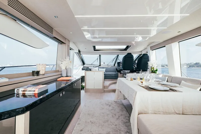 Jam Yacht Photos Pics Luxurious interior of 2018 Sunseeker 74 Sport Yacht with elegant dining area and panoramic windows.