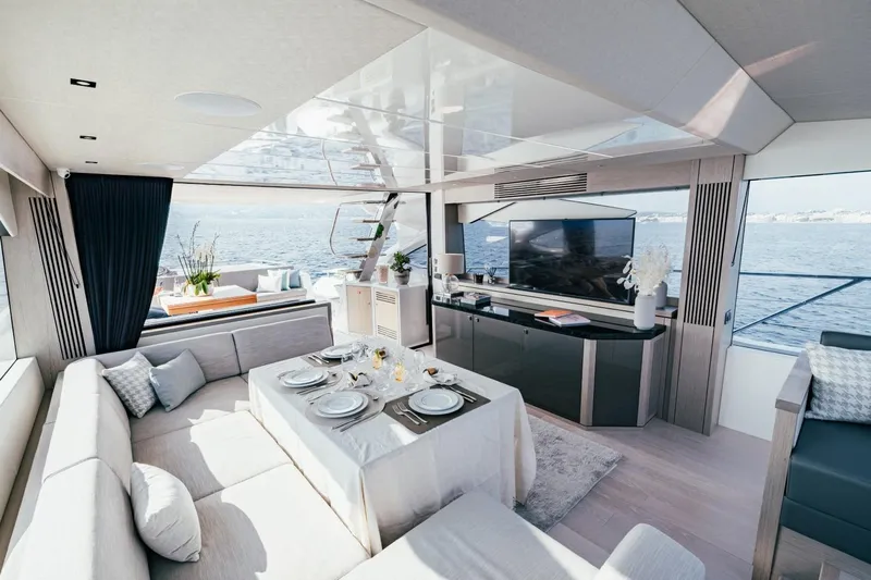 Jam Yacht Photos Pics Luxurious interior of 2018 Sunseeker 74 Sport Yacht with elegant dining setup and sea view.