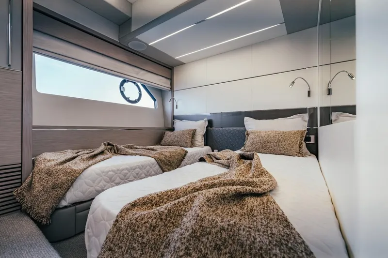 Jam Yacht Photos Pics Luxurious twin bedroom in 2018 Sunseeker 74 Sport Yacht, featuring modern design and cozy bedding.