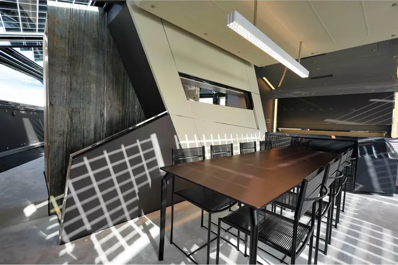  Yacht Photos Pics Modern dining area on 2024 Arcadia Yachts A85, featuring sleek design and ample seating.
