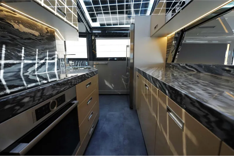  Yacht Photos Pics Luxurious kitchen interior of 2024 Arcadia Yachts A85 with sleek countertops and modern appliances.