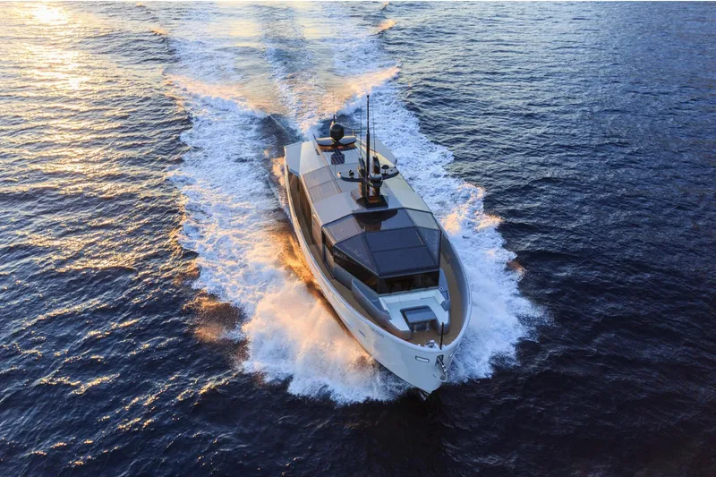  Yacht Photos Pics 2024 Arcadia Yachts A85 cruising on open water at sunset.