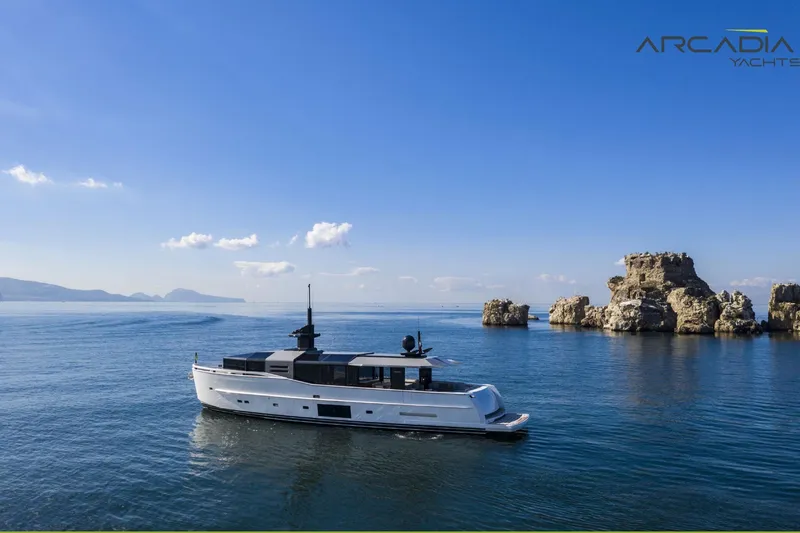  Yacht Photos Pics Luxury Arcadia A85 yacht cruising near rocky coastline, 2024 model.