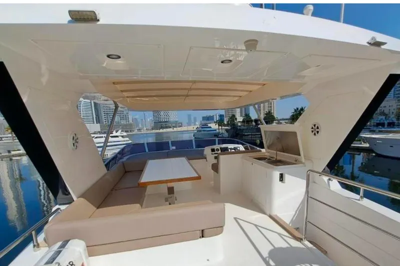  Yacht Photos Pics Luxurious 2018 Gulf Craft Majesty 62 yacht deck with seating and marina view.