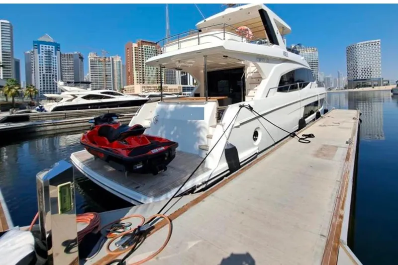 Yacht Photos Pics Luxury Gulf Craft Majesty 62 yacht docked, 2018 model, with jet ski, urban skyline backdrop.
