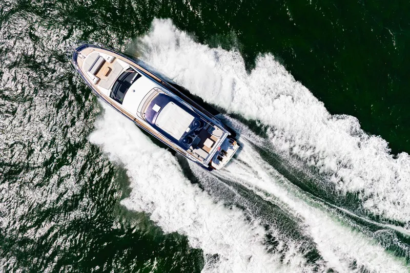  Yacht Photos Pics Aerial view of 2020 Azimut 60 Fly yacht cruising on open water.