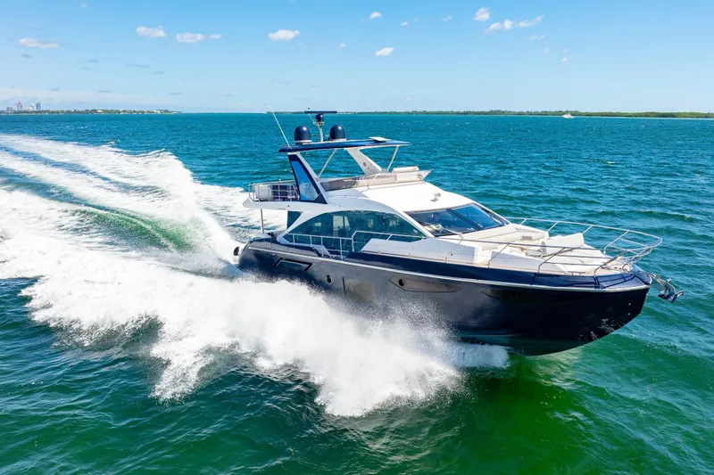  Yacht Photos Pics Azimut 60 Fly 2020 yacht cruising on open water under clear blue skies.